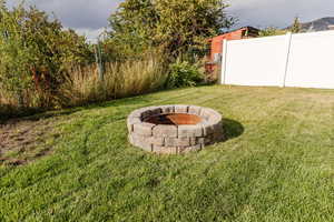 View of yard with an outdoor fire pit
