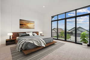 Carpeted bedroom with access to outside, high vaulted ceiling, recessed lighting, and a residential view