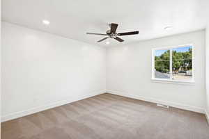 Empty room featuring light carpet, recessed lighting, and ceiling fan