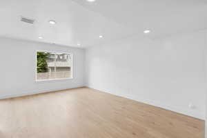 Unfurnished room with recessed lighting and light wood-type flooring