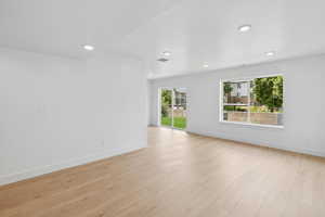 Unfurnished room featuring plenty of natural light, light wood-type flooring, and recessed lighting