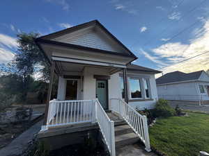 View of front facade with brick siding and a porch