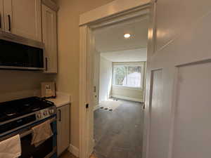 Kitchen with stainless steel appliances, light countertops, a textured ceiling, and recessed lighting