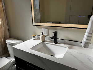 Full bathroom featuring vanity and toilet