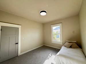 Unfurnished bedroom featuring carpet floors and baseboards