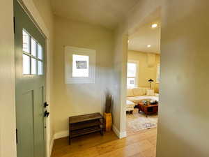 Doorway featuring plenty of natural light, recessed lighting, and wood-type flooring