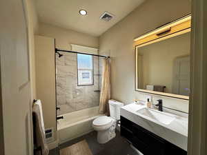 Full bathroom with shower / bath combo and vanity