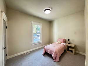 Carpeted bedroom featuring baseboards