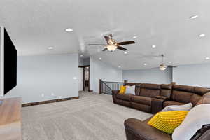 Living room with ceiling fan, light carpet, recessed lighting, and a textured ceiling