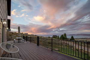 Deck at dusk featuring a mountain view
