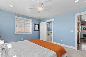 Bedroom featuring a textured ceiling, ensuite bath, a ceiling fan, and recessed lighting