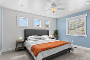 Carpeted bedroom featuring a textured ceiling, a ceiling fan, and recessed lighting