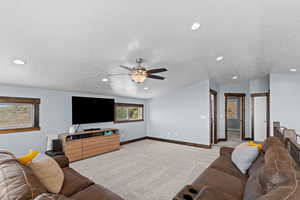 Living room with light colored carpet, recessed lighting, a textured ceiling, and a ceiling fan