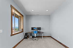 Home office with carpet flooring, recessed lighting, and a textured ceiling