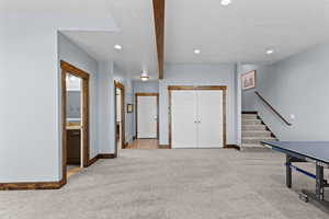 Playroom with light colored carpet, a textured ceiling, beamed ceiling, and recessed lighting