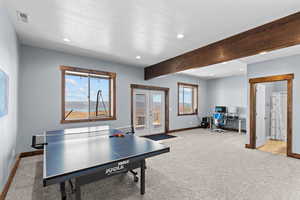 Recreation room with beamed ceiling, french doors, recessed lighting, an office area, and light carpet