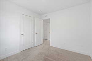 Unfurnished bedroom featuring carpet flooring and baseboards