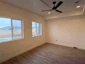 Unfurnished room with recessed lighting, ceiling fan, and dark wood-style floors
