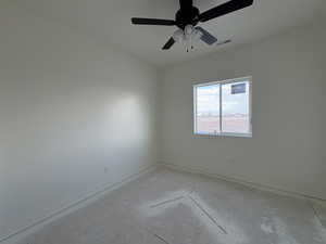 Unfurnished room featuring baseboards and a ceiling fan