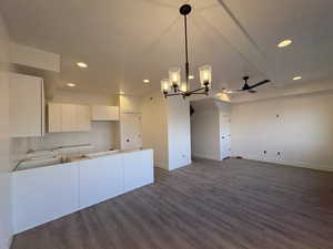 Kitchen with a chandelier, white cabinetry, modern cabinets, recessed lighting, and open floor plan