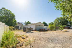 View of yard featuring an outdoor structure and a detached garage