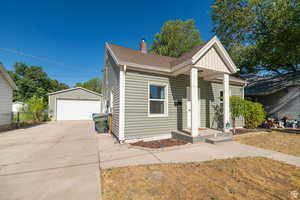 Bungalow featuring an outdoor structure, a detached garage