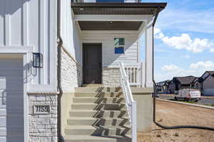 Doorway to property with stone siding