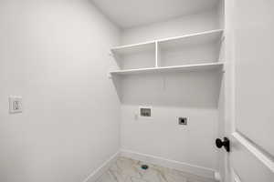 Laundry room featuring light marble finish floors, hookup for a washing machine, and hookup for an electric dryer