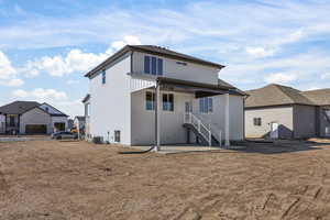 Rear view of property with a patio and stairway