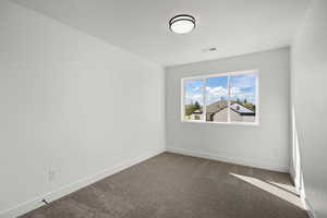 Unfurnished room with carpet and baseboards