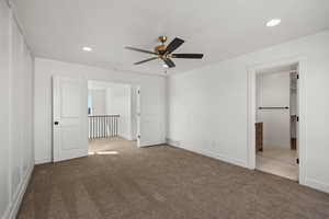 Unfurnished bedroom featuring light colored carpet, recessed lighting, connected bathroom, and ceiling fan