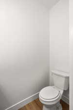 Bathroom featuring wood finished floors and baseboards