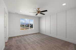 Spare room featuring carpet, a residential view, recessed lighting, and ceiling fan