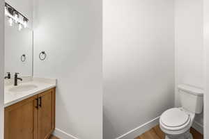 Half bath featuring vanity and light wood-style flooring