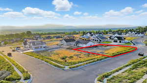 Aerial view of residential area with property boundaries highlighted and mountains