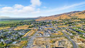 Aerial overview of property's location featuring nearby suburban area and a mountain backdrop