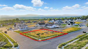 Aerial perspective of suburban area with property boundaries highlighted and mountains