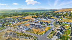 Aerial overview of property's location with nearby suburban area and a mountain backdrop