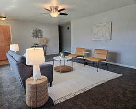 Sitting room with carpet, a textured ceiling, and a ceiling fan