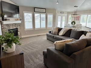 Living area featuring carpet floors, a fireplace, and a textured ceiling