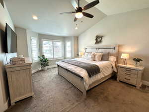 Carpeted bedroom featuring lofted ceiling, a ceiling fan, recessed lighting, and a textured ceiling
