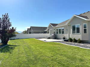 Fenced backyard with a patio
