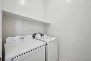 Laundry area featuring washing machine and clothes dryer
