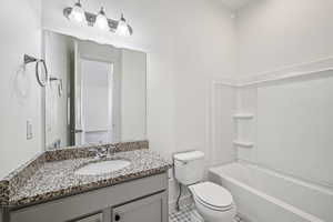Bathroom with vanity,  shower combination, and light tile patterned floors