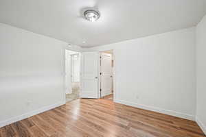 Unfurnished bedroom with light wood-style flooring and baseboards