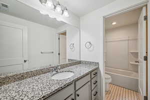 Bathroom with vanity,  shower combination, and light tile patterned floors