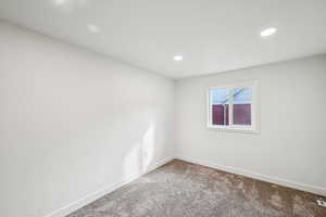 Unfurnished room featuring carpet flooring and recessed lighting