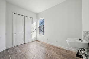 Bathroom featuring baseboards and light wood-style floors