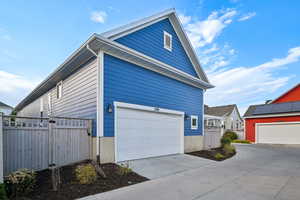 View of home's exterior featuring concrete driveway
