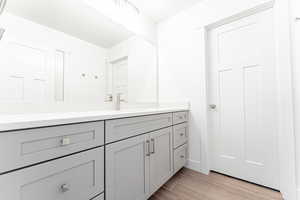 Bathroom featuring vanity and light wood-style floors